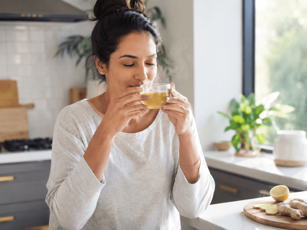 Woman drinking ginger tea for weight loss as part of a healthy daily routine.